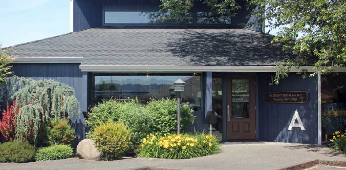 Exterior of calming blue dental office building in Sumner